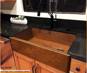 Hammered copper apron sink with a beautiful patina, handcrafted in the USA.