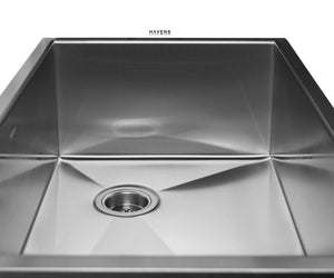 Brushed stainless steel farm style kitchen sink with a rear drain.