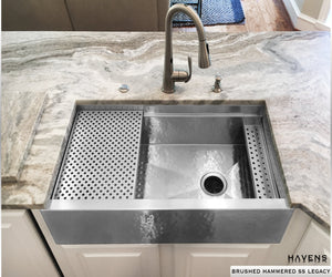 Hammered stainless steel farmhouse sink built from 16 gauge stainless steel. Brushed hammered finish on a workstation Legacy sink by Havens.