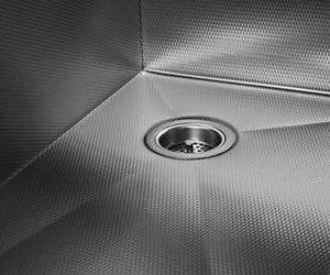 Stainless steel farmhouse sink with a right rear drain and Prestige textured finish.