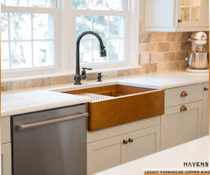 Legacy copper farm style sink with a built in ledge and cutting board.