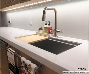 Legacy undermount sink with bamboo cutting board and ledge for advanced sink accessories. 